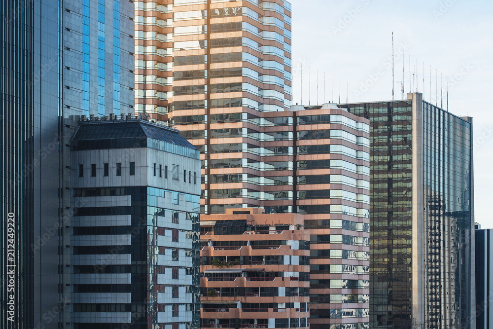 Fototapeta premium Looking up at Big City . City and modern building with sunbeam.