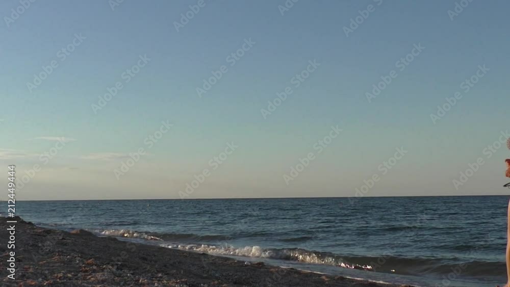 SLOW MOTION: Young woman running in shallow water of sea SLOW MOTION: Young woman running in shallow water of sea