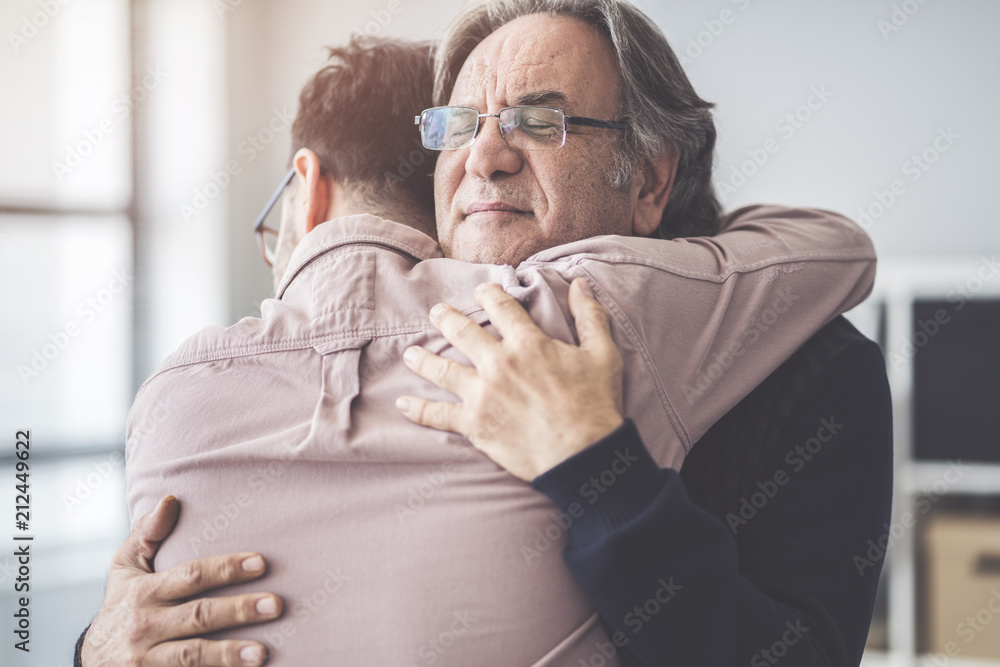 Son hugs his own father - obrazy, fototapety, plakaty 