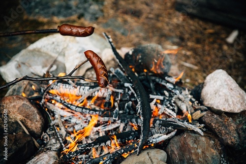 Grilled sausages above the campfire