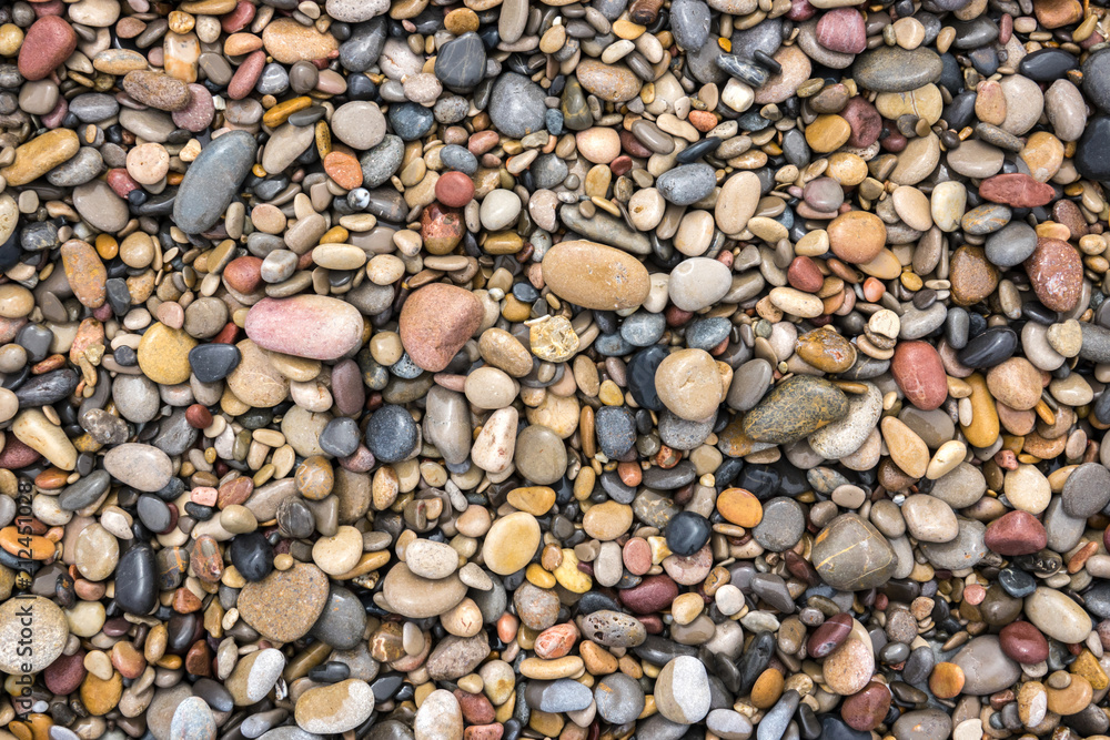 Naklejka premium colorful background texture wet rolling stones wallpaper near sea different size and colours