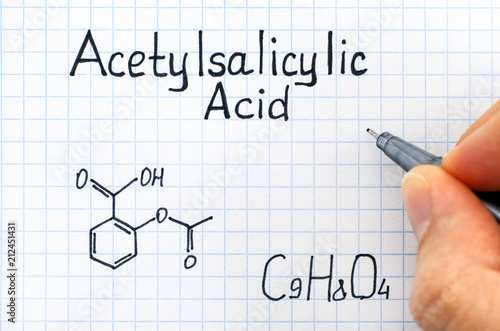 Person hand with pen writing chemical formula of Acetylsalicylic Acid. photo