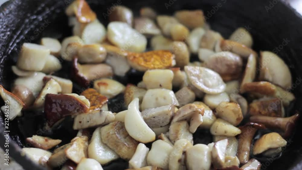 mushrooms champignons in a frying pan mushrooms champignons in a frying pan