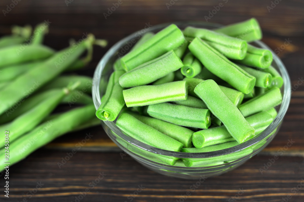 Green beans in the bowl on wooden table Green beans in the bowl on wooden table