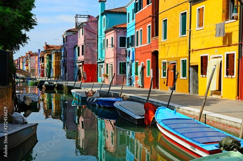 Canal with colorful buildings and houses in Burano island, Venice, Italy - Famous Architecture and landmarks