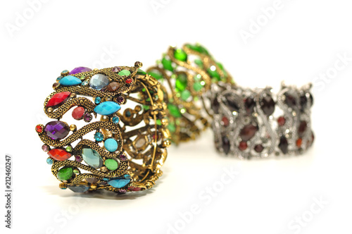 Big wide antic gold silver bangle with colorful gem and rhinestone isolated on white background