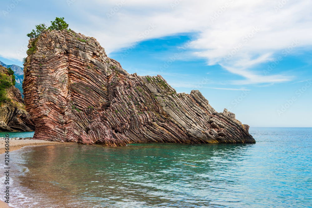 Fototapeta premium Adriatic sea coastline near Budva city in Montenegro, gorgeous seascape with big rock in the beach