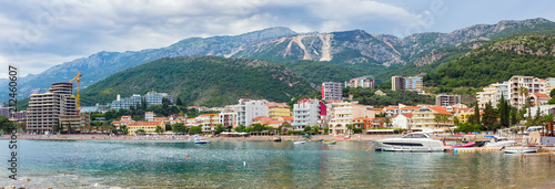 Fototapeta Naklejka Na Ścianę i Meble -  View on the town Becici surrounded by the mountains, before the storm, dramatic clouds near Budva city at Adriatic sea coastline, Montenegro. summer seascape