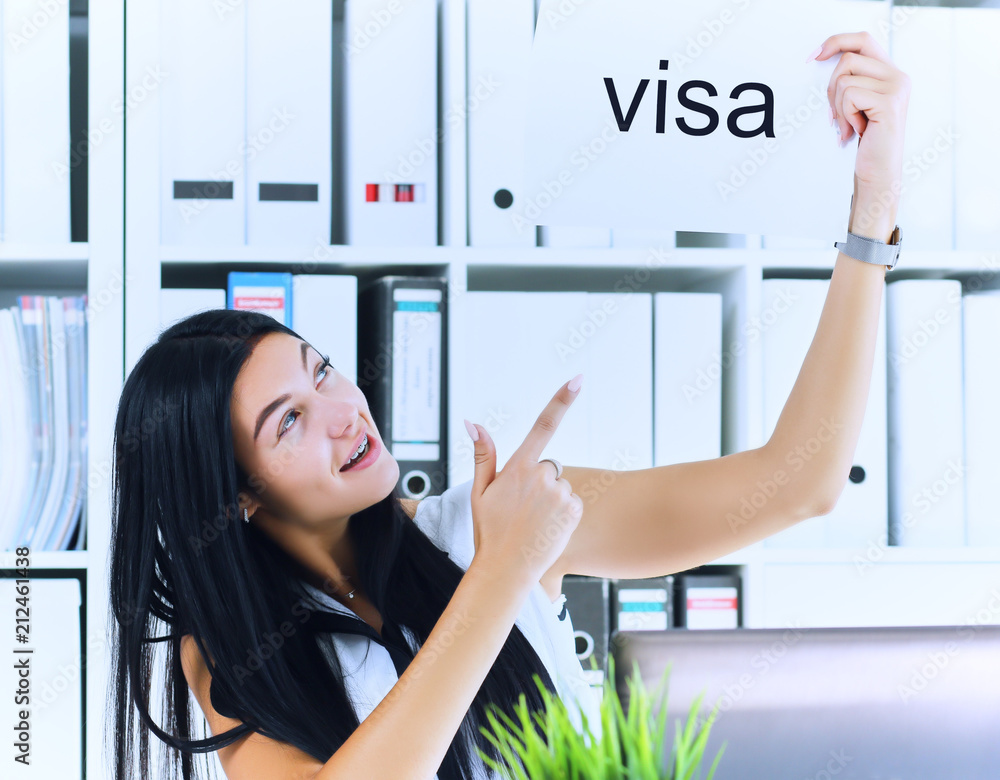 Happy girl holding a poster with the inscription visa. Young girl received  a work visa in the United States. Girl received a visa to continue her  studies abroad. Stock Photo | Adobe