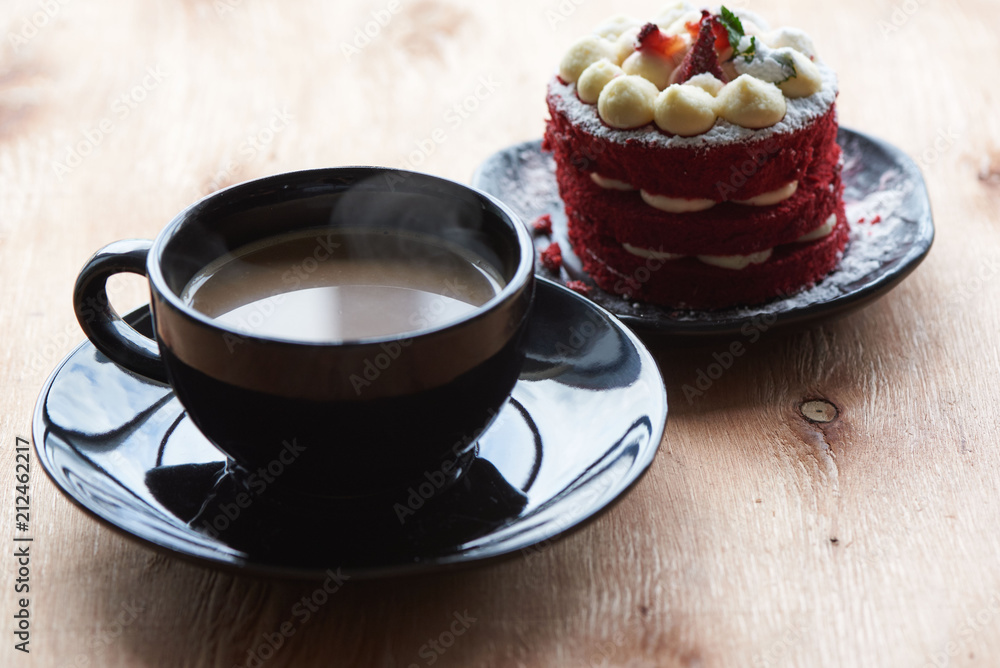 A cup of coffeee and strawberry cake A cup of coffeee and strawberry cake
