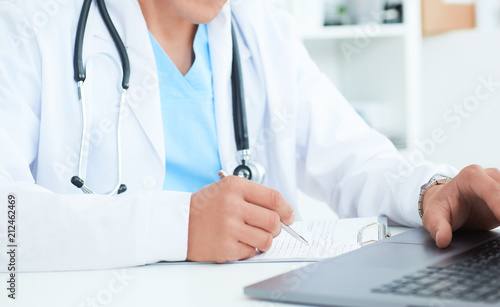 Male doctor, medical students or surgeon using laptop during the conference. Health Check with digital system support for patient, test results and data registration.