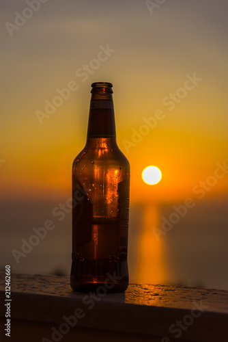 Beer bottle at the sunset