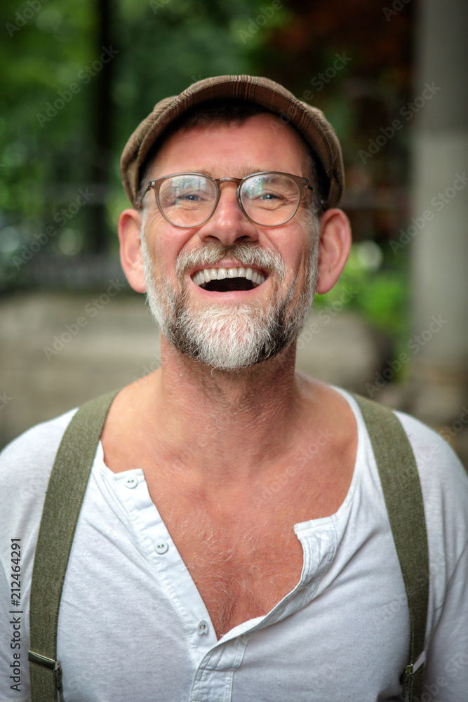 Fototapeta premium portrait of laughing bearded man in his 50s