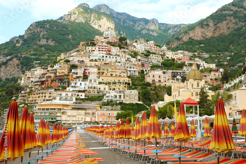 Amazing view of Positano town from the beach with umbrellas and deck chairs, Amalfi Coast, Italy