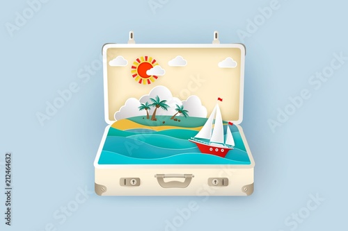 Sea view with a sailboat and tropical island with palm trees inside a suitcase