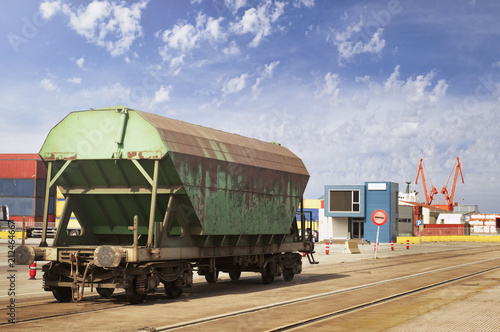 Lonely goods van on a railroad at container terminal in a marine port waiting for cargo