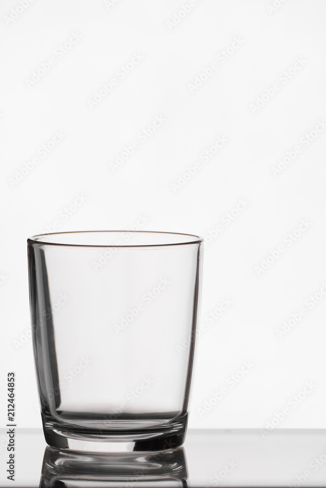 Empty crystal glass with reflection on white isolated background Empty crystal glass with reflection on white isolated background