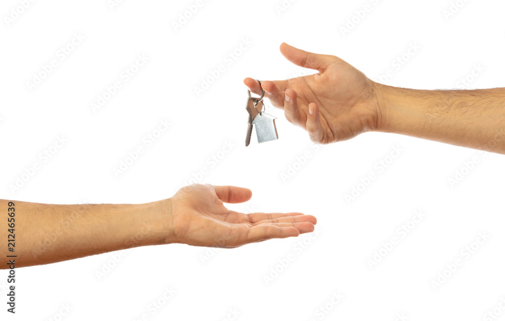 Handing over the house key. Hands isolated on white background, clipping path Handing over the house key. Hands isolated on white background, clipping path
