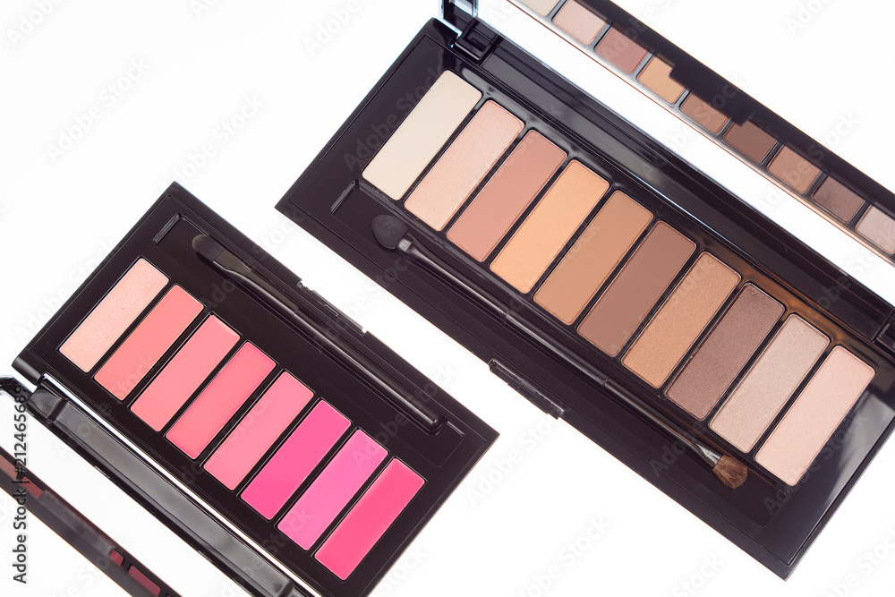 Collection of two cosmetics palettes for eye and lip makeup isolated. Vivid colorful tints, hot colors for face make-up. Lipsticks and eyeshadows kit. Make up means composition. Top view.