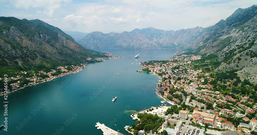 Aerial beautiful View of Kotor bay. Cruise ship docked in beautiful summer day. View of kotor old town from Lovcen mountain in Kotor, Montenegro. Kotor is part of the unesco world. Aerial beautiful View of Kotor bay. Cruise ship docked in beautiful summer day. View of kotor old town from Lovcen mountain in Kotor, Montenegro. Kotor is part of the unesco world.