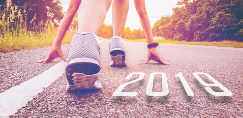 2019 symbolises the start into the new year.Start of people  running on street,with sunset light.Goal of Success