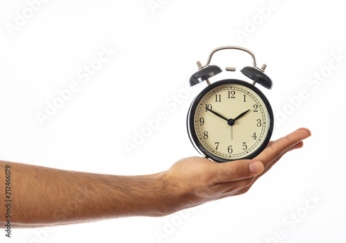 Alarm clock on a hand palm isolated on white background, clipping path