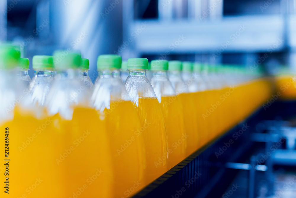 Conveyor with bottles for juice or water. Beverages factory equipments Conveyor with bottles for juice or water. Beverages factory equipments