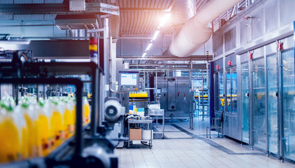 Beverage factory interior. Conveyor with bottles for juice or water. Equipments