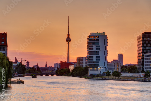 Beautiful orange sky at sunset over Berlin with the famous Television Tower 