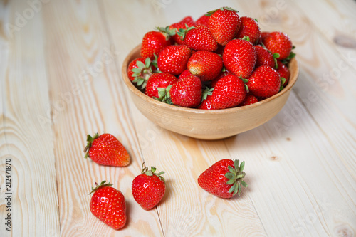 Strawberries in wooden bowl. Fresh nice strawberries on wooden table. Juice strawberry