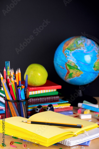 School supplies on blackboard background with copy space.