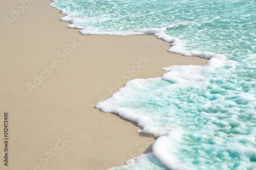 Fototapeta Naklejka Na Ścianę i Meble -  Soft wave and sea bubble of blue sea on sandy beach