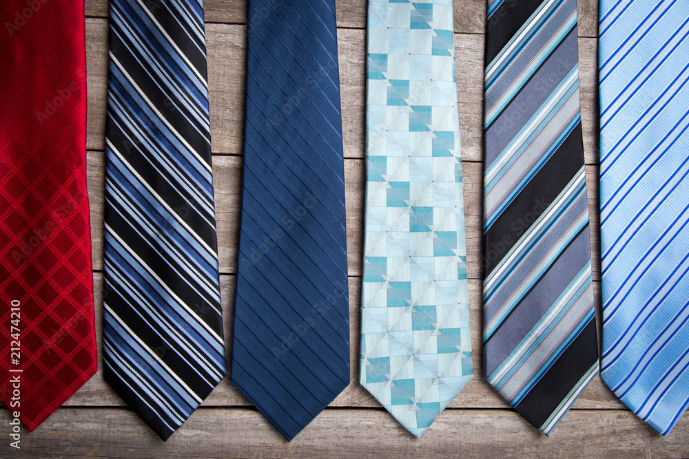 A variety of neck ties on a wooden background A variety of neck ties on a wooden background