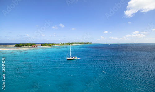 sailing yacht anchoring in the shallow, turquoise lagoon of Fakarava atoll, Tuamotus archipelago, French Polynesia, south pacific