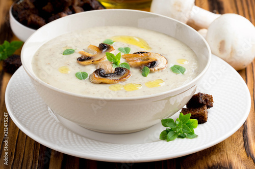 Mushroom cream soup with cream, croutons of dark bread, olive oil, tasty healthy food