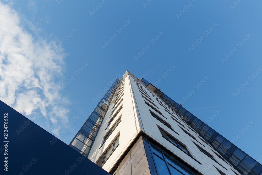 High residential building against a clear sky. Bottom view High residential building against a clear sky. Bottom view