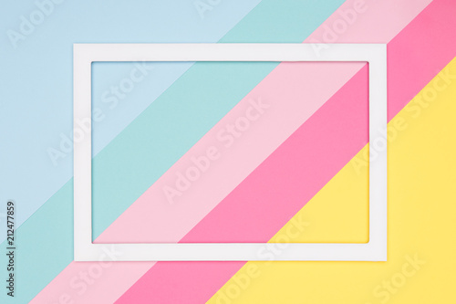 Abstract geometrical pastel blue, pink and yellow paper flat lay background. Minimalism, geometry and symmetry template with empty picture frame mock up.