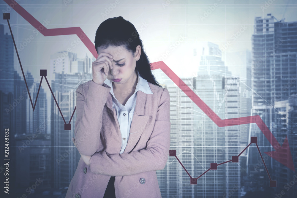 Caucasian businesswoman with declining statistic Caucasian businesswoman with declining statistic