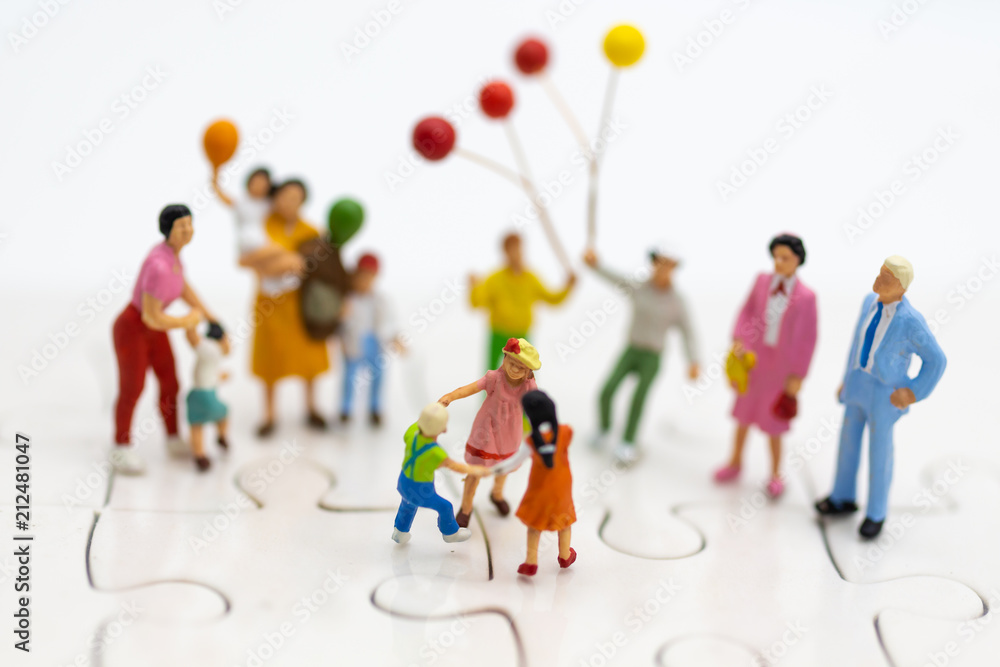 Fototapeta premium Miniature family: Childrens playing balloon together. Image use for background International day of families concept.