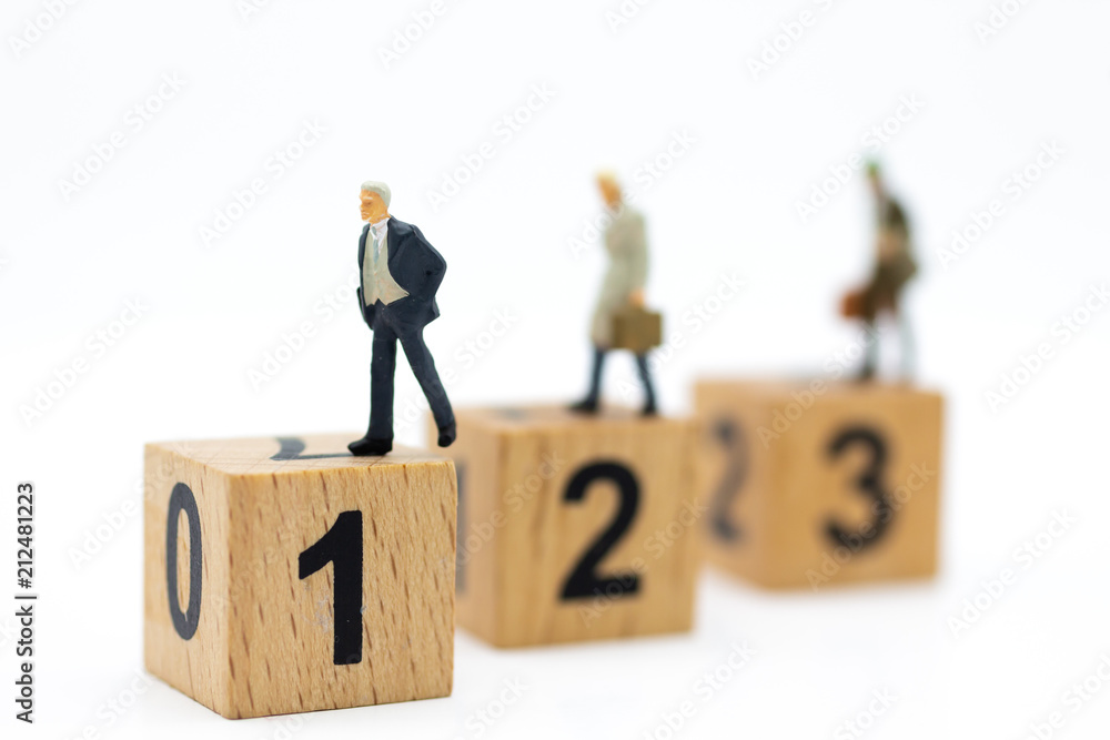 Miniature people : Businessman standing on wooden blocks with sequential numbers. Image use for business concept. Miniature people : Businessman standing on wooden blocks with sequential numbers. Image use for business concept.