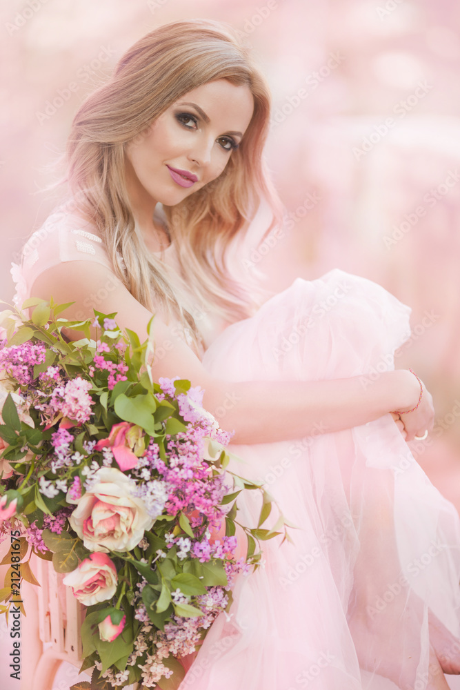 Woman in long dress and floral wreath standing on green nature background Woman in long dress and floral wreath standing on green nature background