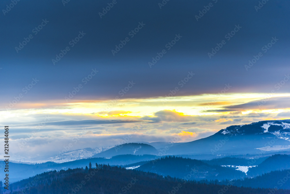 Fantastic colors of clouds at the sunset in Carpathians Mountains