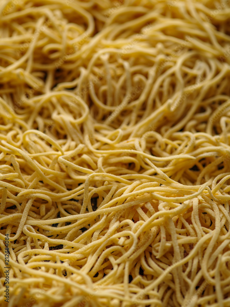 Dried egg noodles. Raw Fresh Spaghetti. Food background