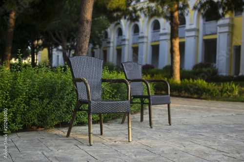 wicker straw chairs in the yard © Alsu