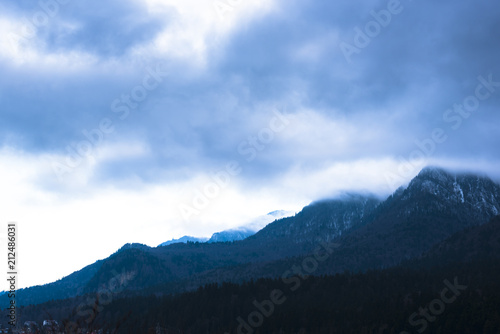 Fototapeta Naklejka Na Ścianę i Meble -  Fantastic clouds in the Caraiman Mountains at the sunset winter, Busteni, Romania