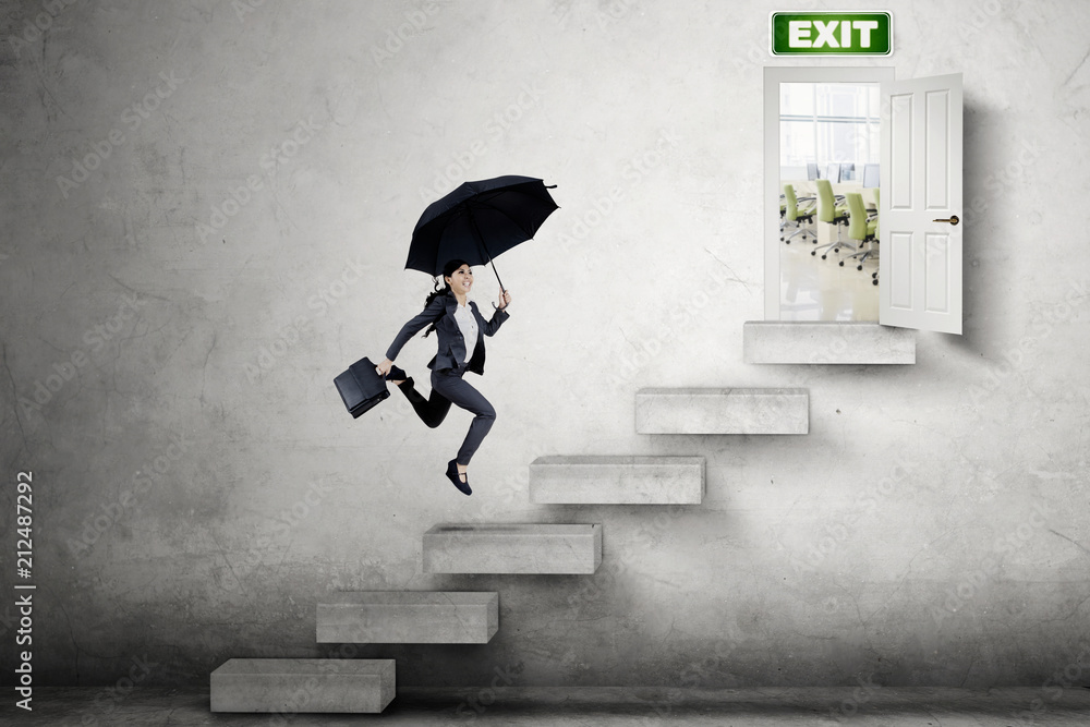 Young businesswoman runs toward the exit door Young businesswoman runs toward the exit door