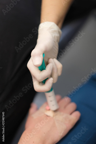 The doctor anesthesiologist injects the sedative intravenously into the patient via a catheter