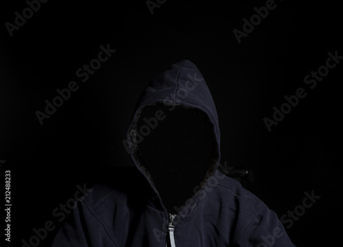 Anonymous criminal man in hood
