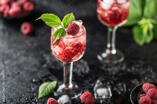 Fresh raspberry cocktail. Fresh summer cocktail with raspberry and ice cubes. Glass of raspberry mojito