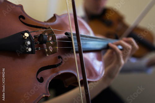 Girl playing the violin. Old violin close-up